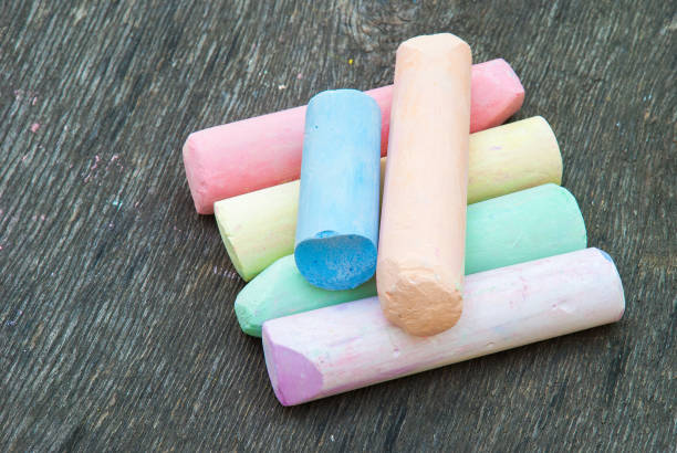 istock Colored chalk for drawing on a wooden background 1022389292