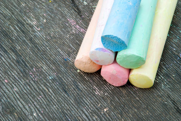 istock Colored chalk for drawing on a wooden background 1022389364