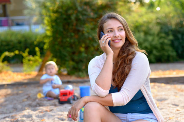 istock Attractive young mother talking on her mobile 1022389684