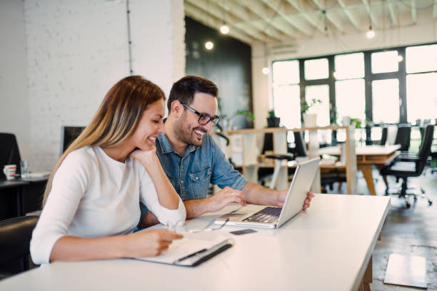 istock Two casually dressed young business colleagues working on a project. 1022389762