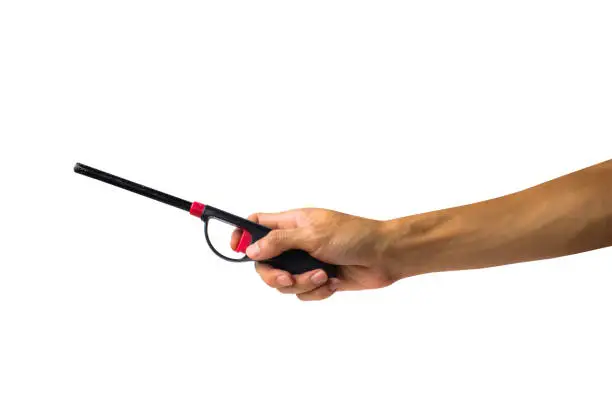 A cropped of female hand holding gas lighter gun against white background include clipping path.