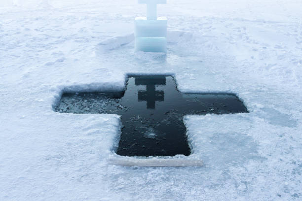 Holidays of Orthodox baptism. Ice cross hole and a cross of ice in Russia