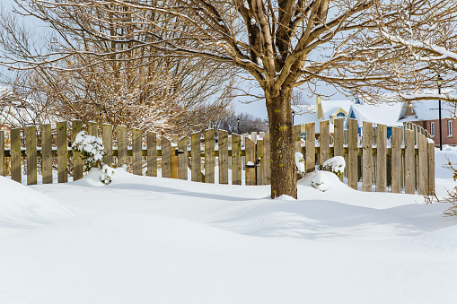 Garden gate of a suburban garden buried in snow.