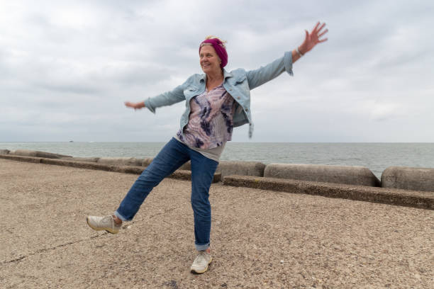 istock Blurred motion image of a 73 yrs old female balancing on left foot. 1022404608
