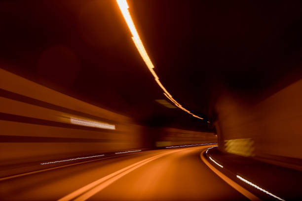A long exposure while driving through a tunnel in the Swiss Alps. The shutterspeed creates a warp-like effect.