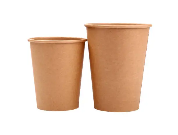 Close up group of two empty brown paper parchment coffee to go cups, big and small,  isolated on white background, low angle side view