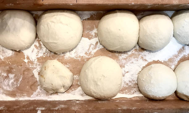 istock Raw Bread Dough Ball Shaped for Turkish Pide in Wooden Box. 1022416480