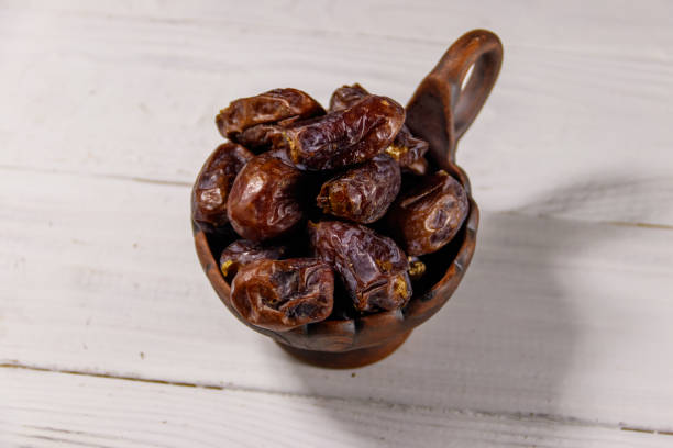 istock Dried dates fruit on white wooden table 1022424064