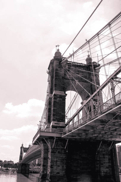 Black and white photo of the John A. Roebling Suspension Bridge, which connects Cincinnati, OH to Covington, KY. This photo was shot from the Cincinnati side of the Ohio River