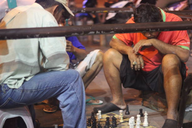 Malioboro, Yogyakarta, Indonesia - 14 August 2018: Every night along Malioboro street there are many visitors. if visitors are not crowded, food and beverage sellers will continue to sell as usual. to spend their free time doing other activities such as playing chess with other people.