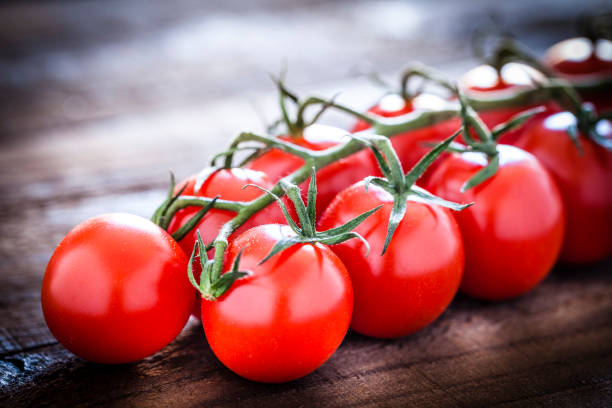 istock Fresh ripe cherry tomatoes on dark wooden table 1022444320