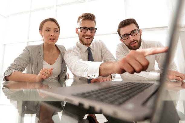 istock close up.smiling businessman pointing at laptop screen 1022452862