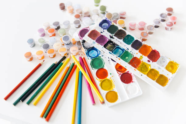 istock Set of watercolor paints and paintbrushes on a table 1022456718