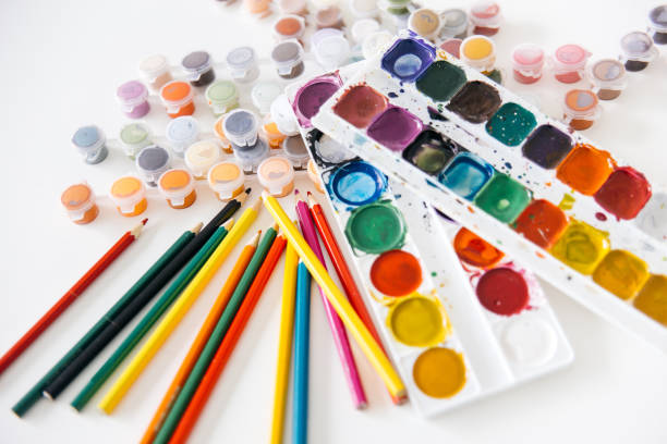 istock Set of watercolor paints and paintbrushes on a table 1022456784
