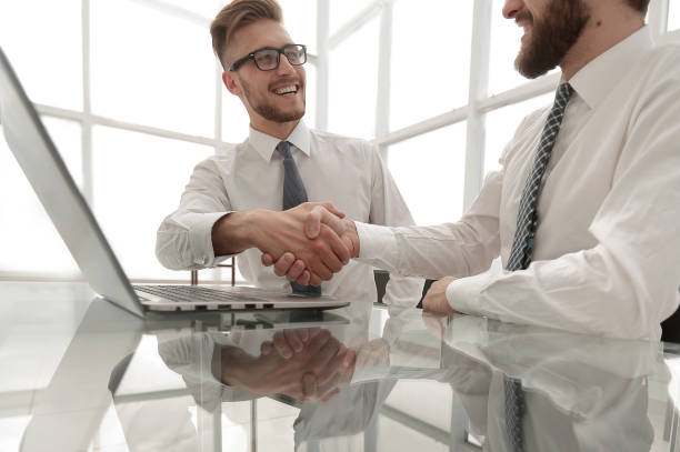 istock side view.business colleagues shaking hands in the workplace 1022457180