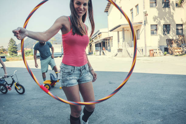 istock Young woman with plastic hula hoop ring 1022463280