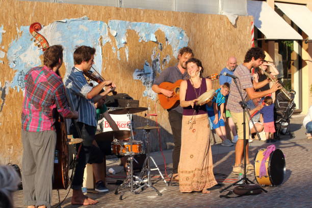 Artists perform in the street. Buskers Festival Ferrara, Italia - August 18, 2018: The Ferrara Buskers Festival is dedicated to the art of the street. Artists sing their music perform in the street. Artists Mombè contra bassoon stock pictures, royalty-free photos & images