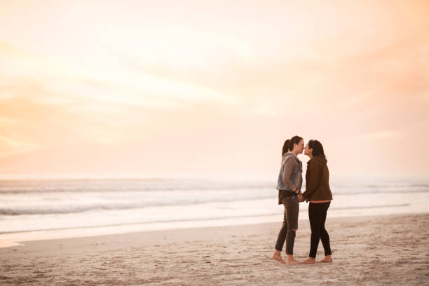 istock Two lovers about to kiss at sunset on the beach 1022473910