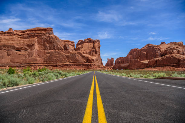 istock Winding Utah road, mountains, double yellow lines 1022477074