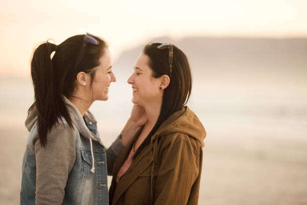 istock Lovers smiling face to face at sunset on the beach 1022481298