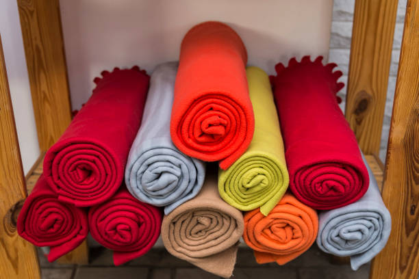 Several colorful plaids on the shelf