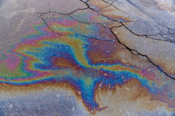istock Gasoline stains on asphalt with cracks 1022490324