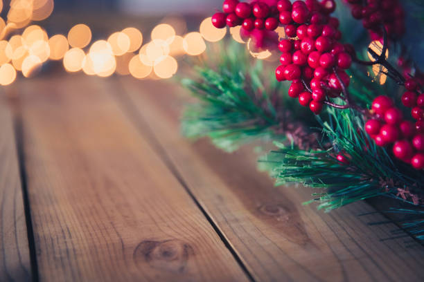 istock Christmas Holly on Wood Background 1022505794