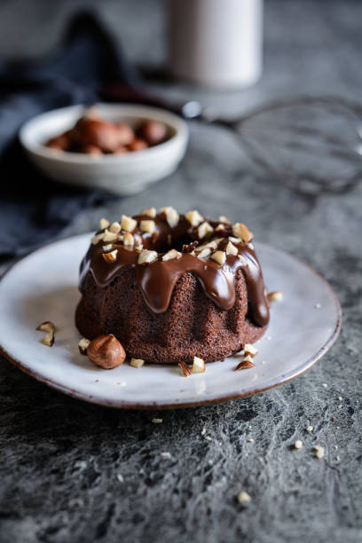 istock Mini chocolate bundt cakes topped with glaze and hazelnuts 1022509184