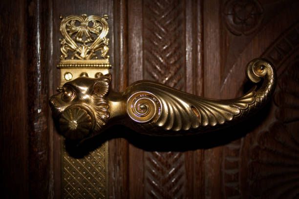 The metal stylized door handle on Pecs Basilica door from close