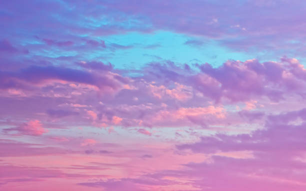istock Pink And Serene Fluffy Cumulus Clouds 1022530428