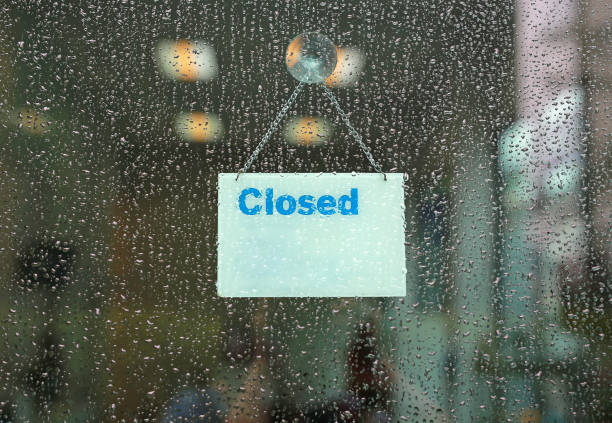 istock Rain drop with Closed sign board hanging on glass door. 1022530496