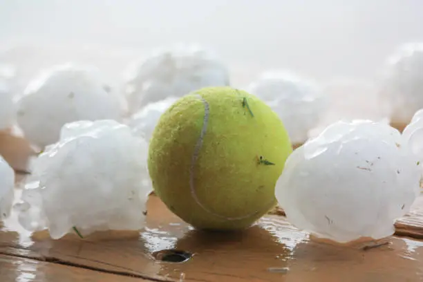 Hailstones next to tennis ball