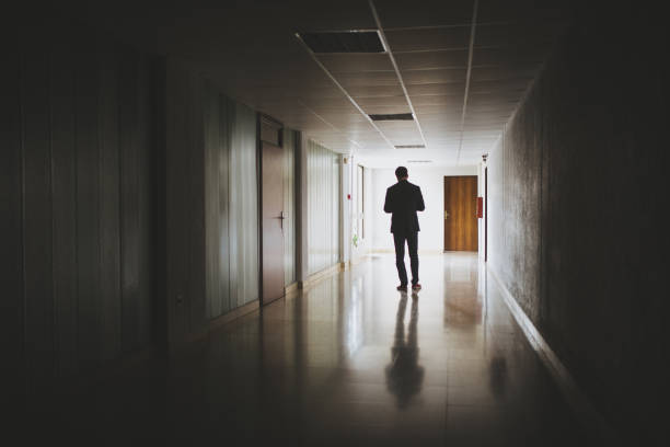istock Businessman walking in a dark hallway 1022541270
