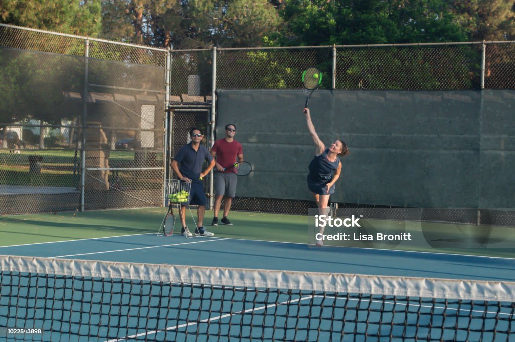 Mixed doubles tennis lessons Mixed doubles tennis lesson in summer in Los Angeles Active Lifestyle Stock Photo