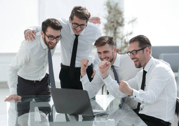 istock triumphant business team looking at the laptop screen 1022546924