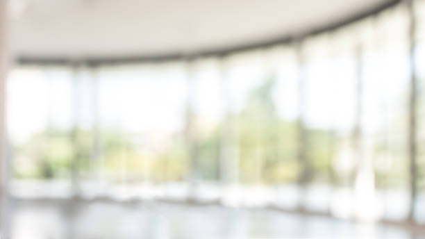 istock Blur background interior view looking out toward to empty office lobby and entrance doors and glass curtain wall 1022551672