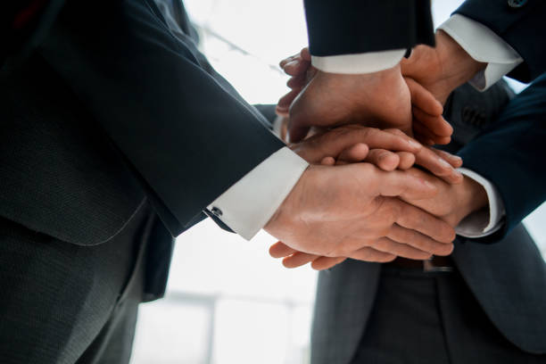 istock Close-up of businesspeople stacking hands in meeting 1022556708