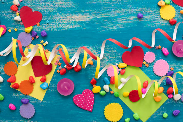 istock Decorative holiday background with streamers confetti candy hearts decor. 1022572952