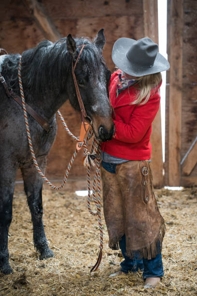 istock Pretty woman with horse inside a barn 1022577606