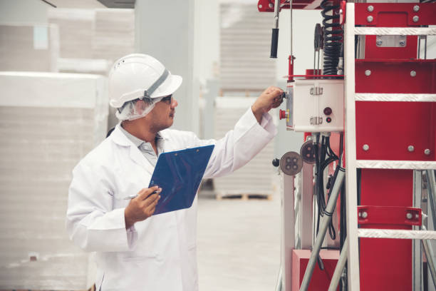 istock Young man white uniform checking machine equipment at store factory 1022585242