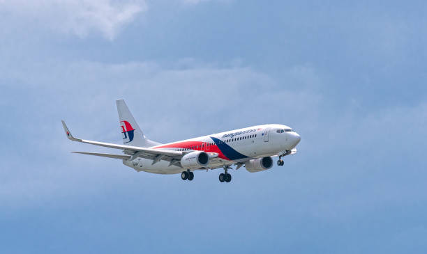Passenger aircraft Boeing 737 of Malaysia Airlines fly in sky stock photo