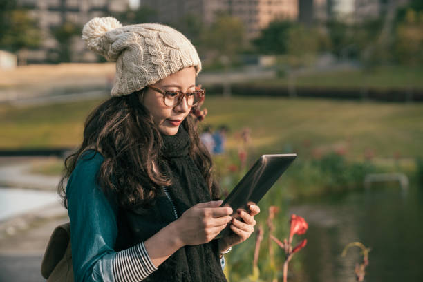 istock casual pretty girl using the digital tablet 1022595306