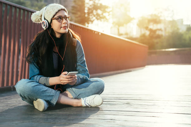 istock woman enjoys smartphone music 1022597420