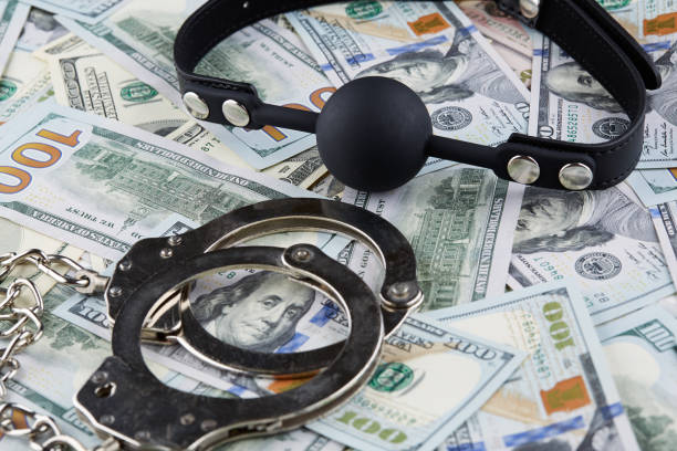 istock Black gag and handcuffs on american dollars banknotes 1022600064