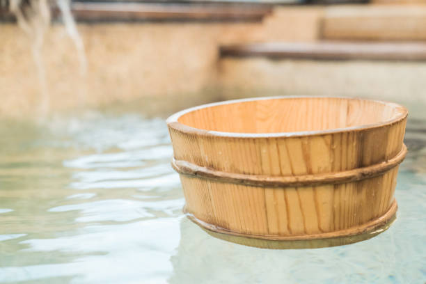 istock wooden barrel scoop floating on hot spring 1022607636