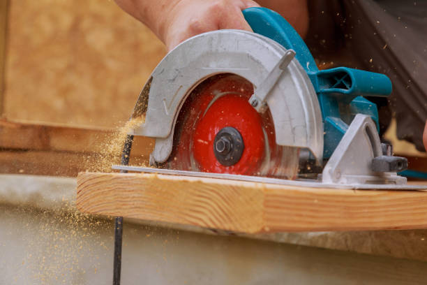 istock Building contractor worker using hand held worm drive circular saw to cut boards on a new home constructiion project 1022608756