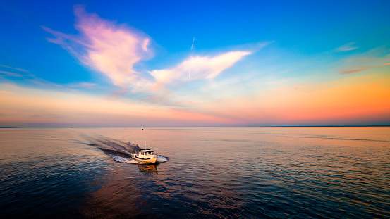 Beautiful sunset and clouds seen at Lake Superior, Duluth, Minnesota, Near Canal Park. Sailboats.