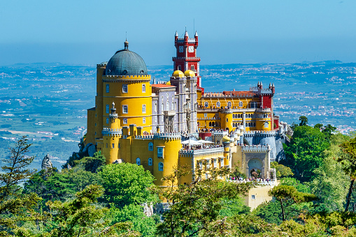 Extravagant Pena Palace in Sintra, Portugal. Photo taken from a nearby lookout during a warm summer day.