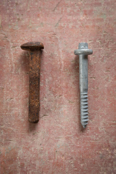 rusted old and modern galvanized australian railway nails on stone background - railroad spikes imagens e fotografias de stock