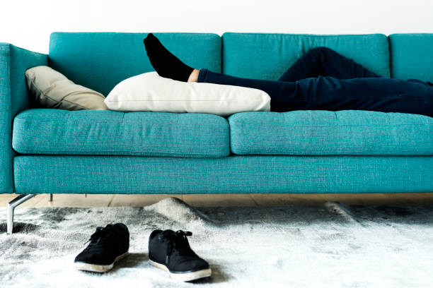 Man sleeping on the sofa Man sleeping on the sofa napping stock pictures, royalty-free photos & images